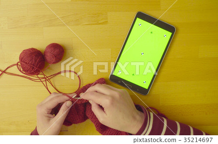 Green screen. Female hands knitting wool 35214697
