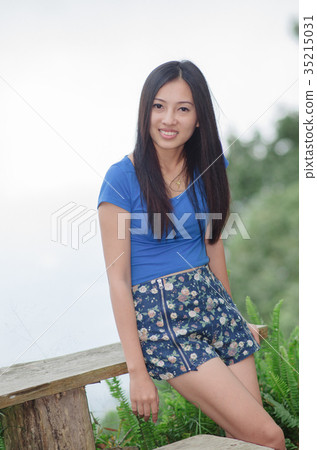 Asia young shy women sitting and smile on wood long chair Asia young shy women sitting and smile on wood long chair 35215031
