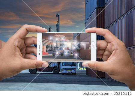 Hand holding smartphone is pressing button  35215115