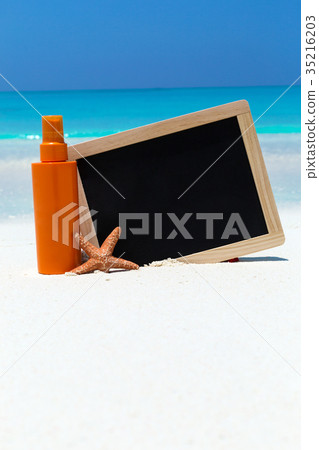 Sunscreen lotion in orange tube with chalk board 35216203