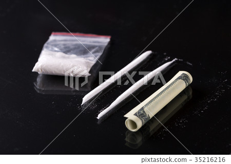 Rolled hundred dollars banknote and cocaine Rolled hundred dollars banknote and cocaine 35216216