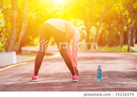 Fitness woman runner stretching before jogging 35216379