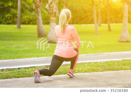 Fitness woman runner stretching before jogging 35216380