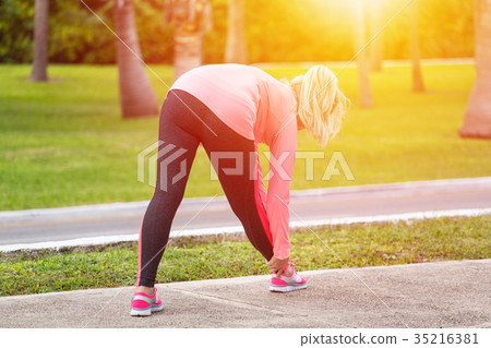 Fitness woman runner stretching before jogging 35216381