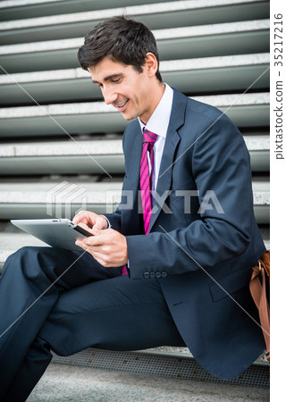 Businessman using a tablet for communication or 35217216