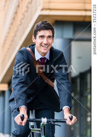 Active young man smiling while riding utility 35217218