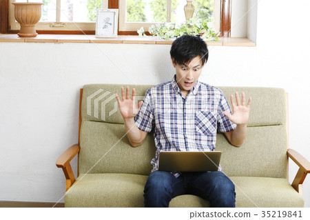 Portrait of young man using a computer Portrait of young man using a computer 35219841
