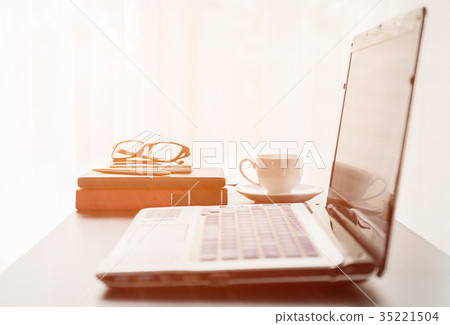 Laptop placed on desktop with coffee cup 35221504