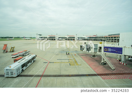 Ground crew directing an incoming airplane  35224283