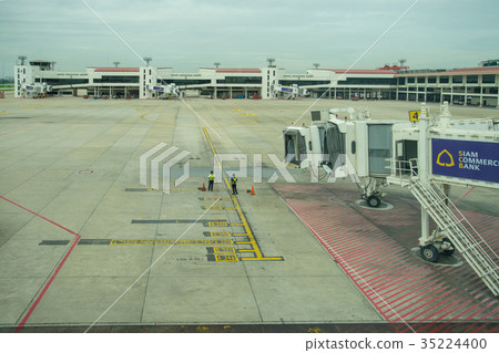 Ground crew directing an incoming airplane Ground crew directing an incoming airplane 35224400