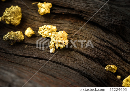 Pure gold ore on old wooden floor 35224693