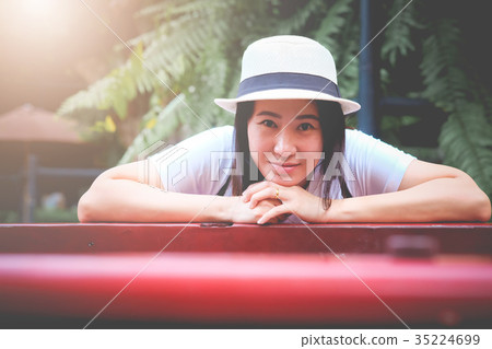Asian woman tourist put face on hand and smiling. 35224699