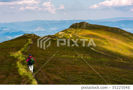 tourist on a foot path of mountain ridge 35225048
