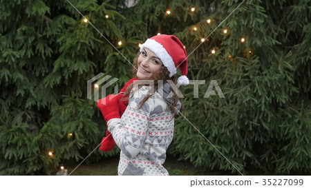 Cheerful woman in Santa hat with red scarf and 35227099