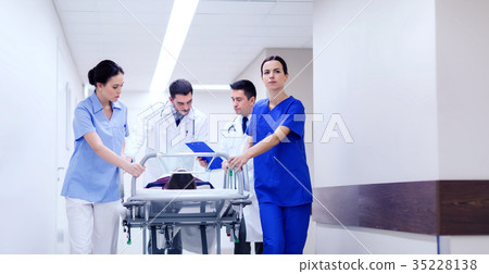 medics with woman on hospital gurney at emergency 35228138