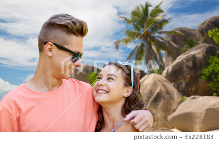happy teenage couple hugging at summer beach happy teenage couple hugging at summer beach 35228183