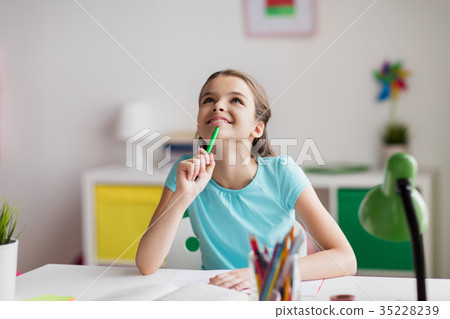 happy girl with book and notebook dreaming at home 35228239