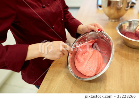 chef making macaron batter at confectionery chef making macaron batter at confectionery 35228266