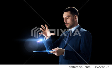 businessman in suit with transparent tablet pc businessman in suit with transparent tablet pc 35228326