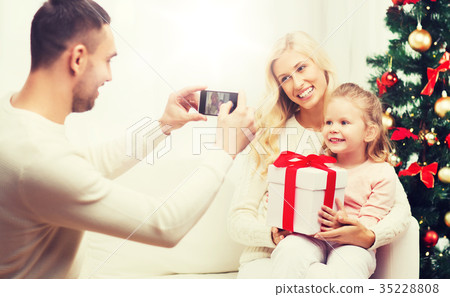 family taking picture with smartphone at christmas 35228808