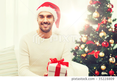 happy man with christmas gift box at home 35228809