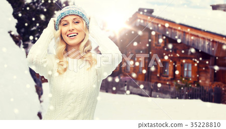 smiling young woman in winter hat and sweater smiling young woman in winter hat and sweater 35228810