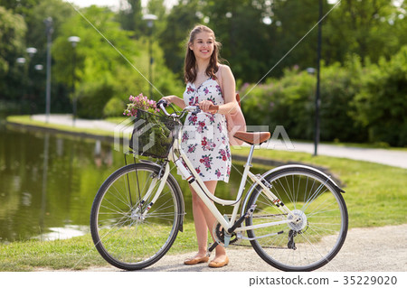 happy woman riding fixie bicycle in summer park happy woman riding fixie bicycle in summer park 35229020