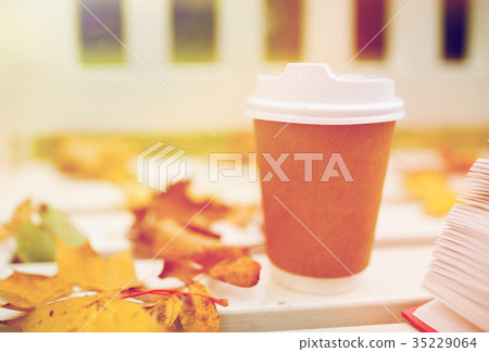 coffee drink in paper cup on bench at autumn park coffee drink in paper cup on bench at autumn park 35229064