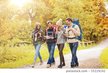 group of smiling friends with backpacks hiking 35229142