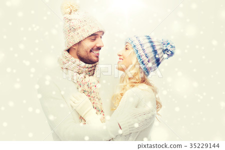 smiling couple in winter clothes hugging 35229144