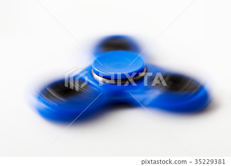 close up of blue spinning fidget spinner 35229381