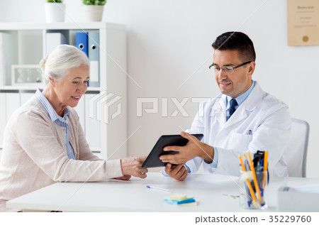senior woman and doctor with tablet pc at hospital senior woman and doctor with tablet pc at hospital 35229760