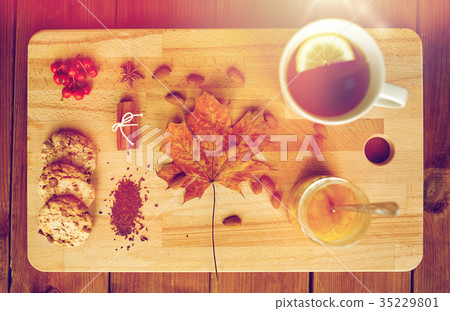 cup of tea with lemon, honey and cookies on board cup of tea with lemon, honey and cookies on board 35229801