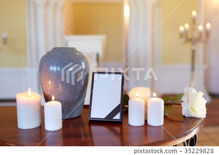 photo frame, cremation urn and candles in church photo frame, cremation urn and candles in church 35229828