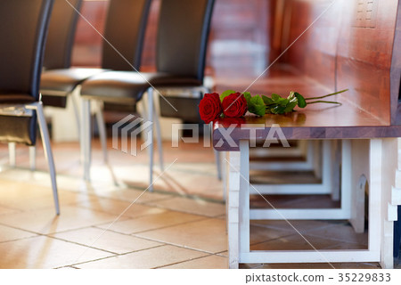 red roses on bench at funeral in church red roses on bench at funeral in church 35229833