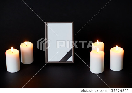 black ribbon on photo frame and candles at funeral black ribbon on photo frame and candles at funeral 35229835