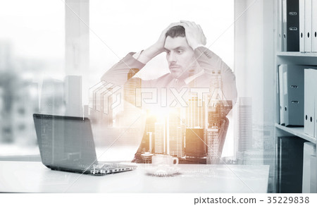 stressing businessman with laptop at office stressing businessman with laptop at office 35229838