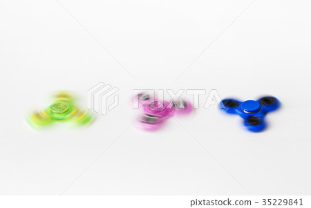 three spinning fidget spinners on white background three spinning fidget spinners on white background 35229841
