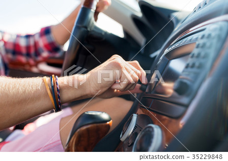 man driving car and turning switch on dashboard 35229848