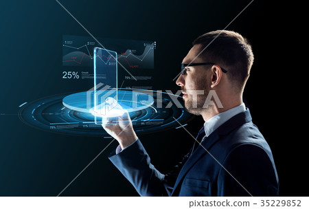 businessman with tablet pc and virtual charts businessman with tablet pc and virtual charts 35229852
