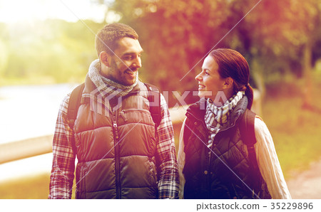 happy family walking with backpacks in woods happy family walking with backpacks in woods 35229896