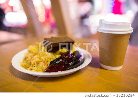braised cabbage and sausages with sauce on plate braised cabbage and sausages with sauce on plate 35230284