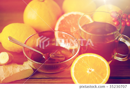 tea with honey, lemon and ginger on wood tea with honey, lemon and ginger on wood 35230707