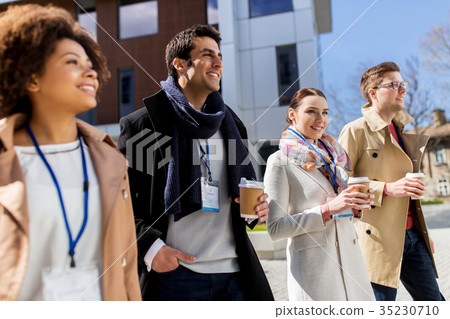 people with coffee and conference badges in city people with coffee and conference badges in city 35230710