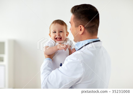 happy doctor or pediatrician with baby at clinic 35231008