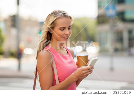 woman with coffee and smartphone in city woman with coffee and smartphone in city 35231099