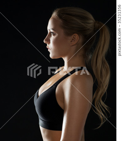 young woman in black sportswear posing in gym young woman in black sportswear posing in gym 35231356