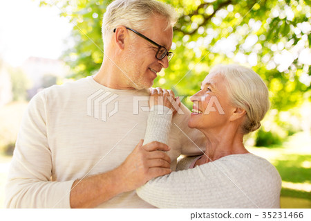 happy senior couple hugging at summer park happy senior couple hugging at summer park 35231466