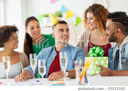 team greeting colleague at office birthday party team greeting colleague at office birthday party 35231583