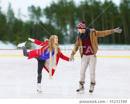 happy couple holding hands on skating rink happy couple holding hands on skating rink 35231599
